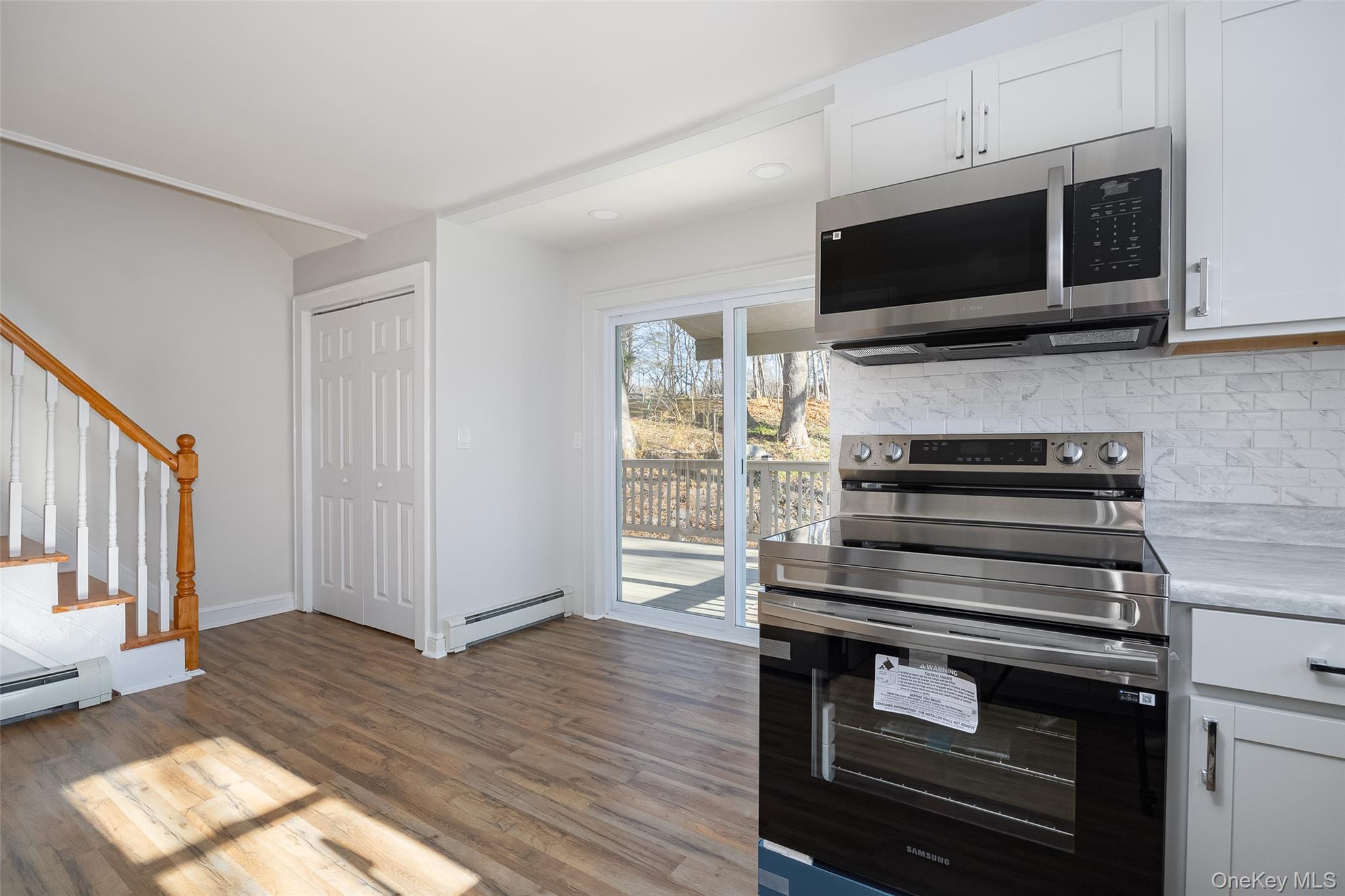 4 Walnut Street Poughkeepsie, NY 12601 - Photo 5 of 26 a kitchen with a stove and a microwave