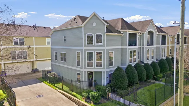 a front view of a house with a garden and plants