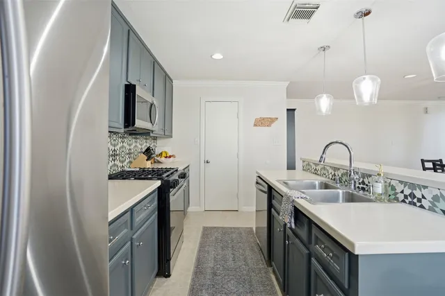 a kitchen with stainless steel appliances granite countertop a sink and stove