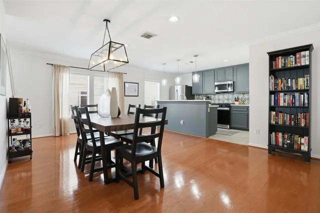 a view of a dining room with furniture and wooden floor