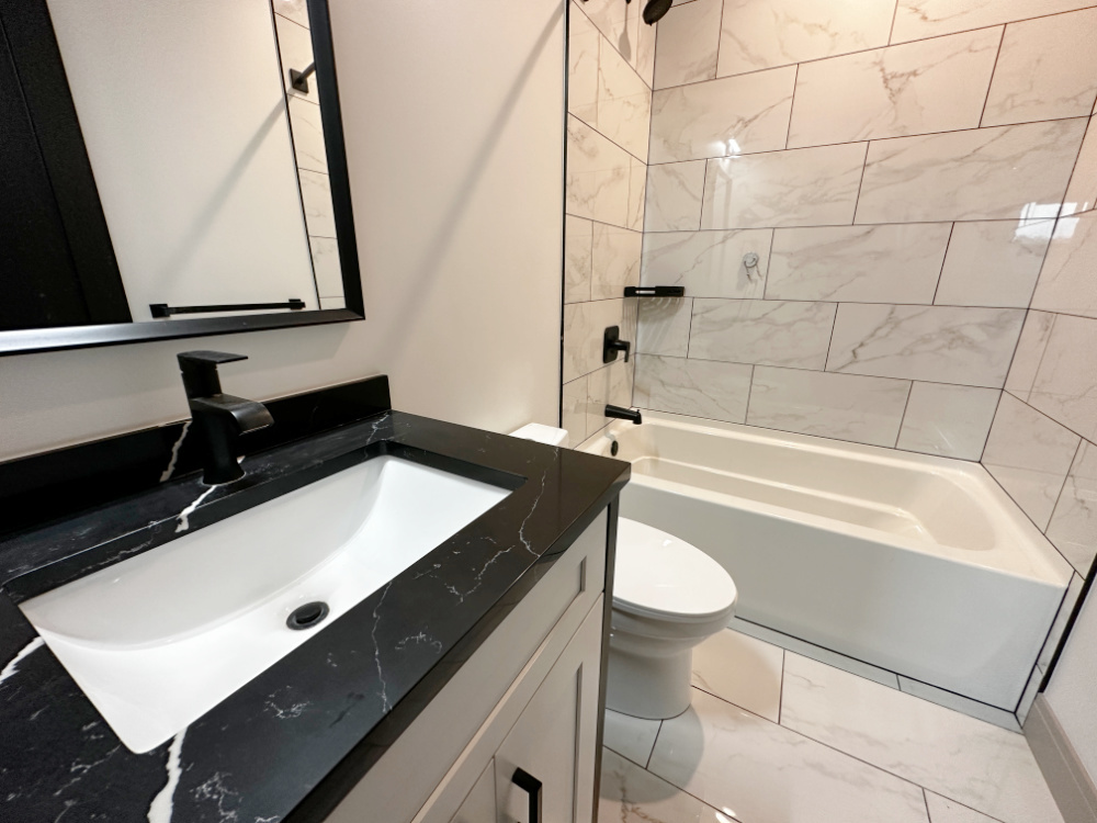 4054 South Indiana Avenue, Unit 2R Chicago, IL 60653 - Photo 11 of 17 a bathroom with a sink a toilet a mirror and bathtub