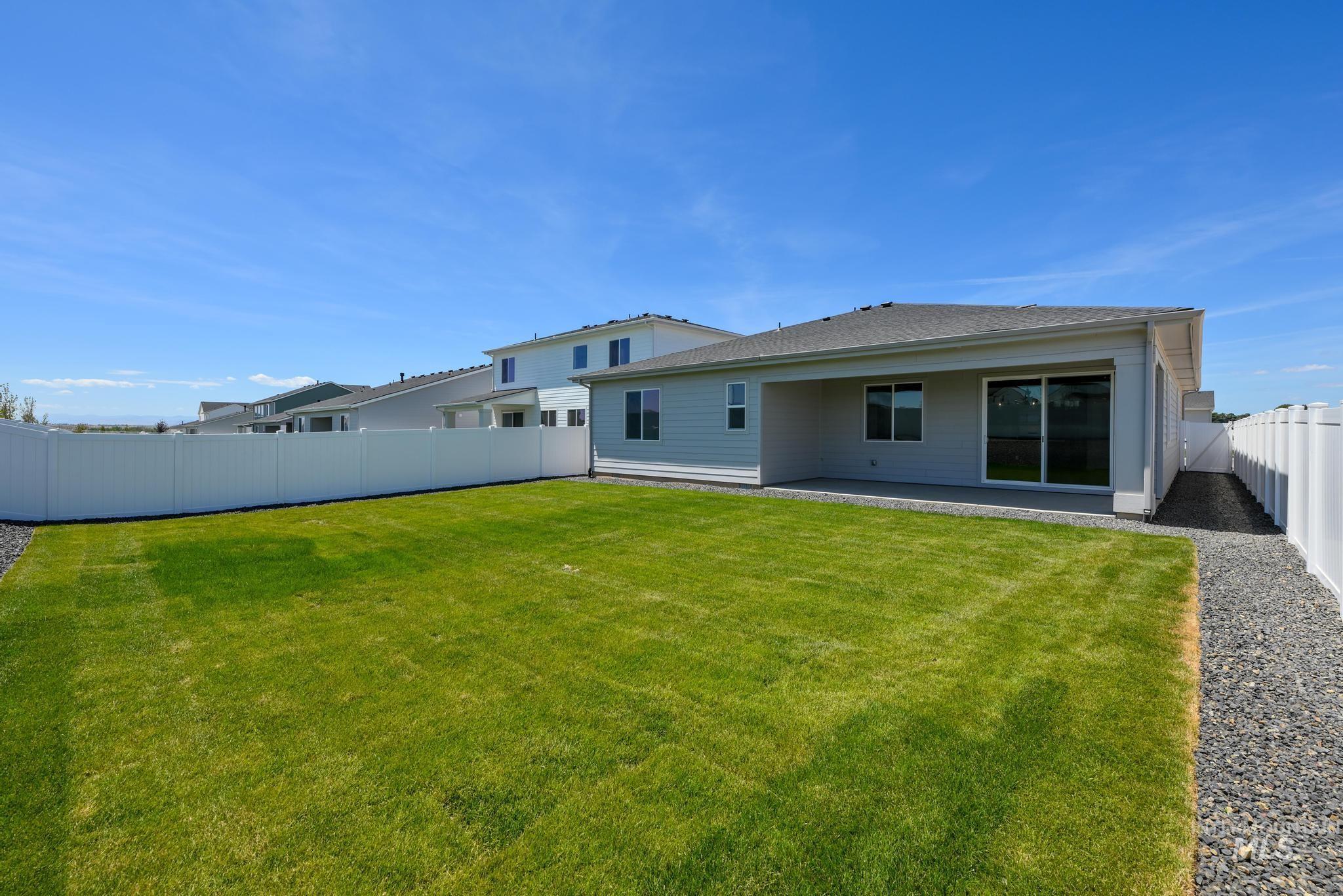 1745 West Arya Street Kuna, ID 83634 - Photo 11 of 11 Back of house featuring a patio area and a fenced backyard