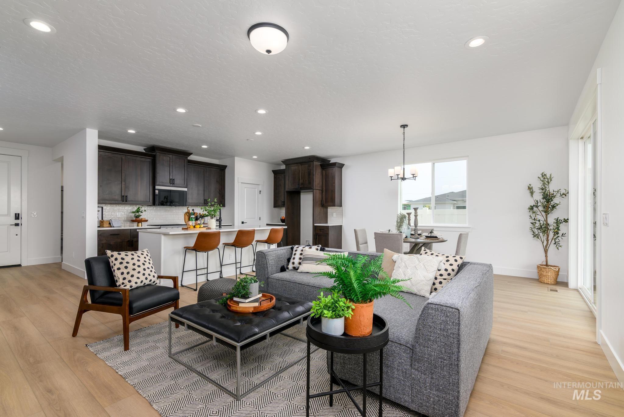1745 West Arya Street Kuna, ID 83634 - Photo 2 of 11 Living room with light wood-style floors and suspended lighting