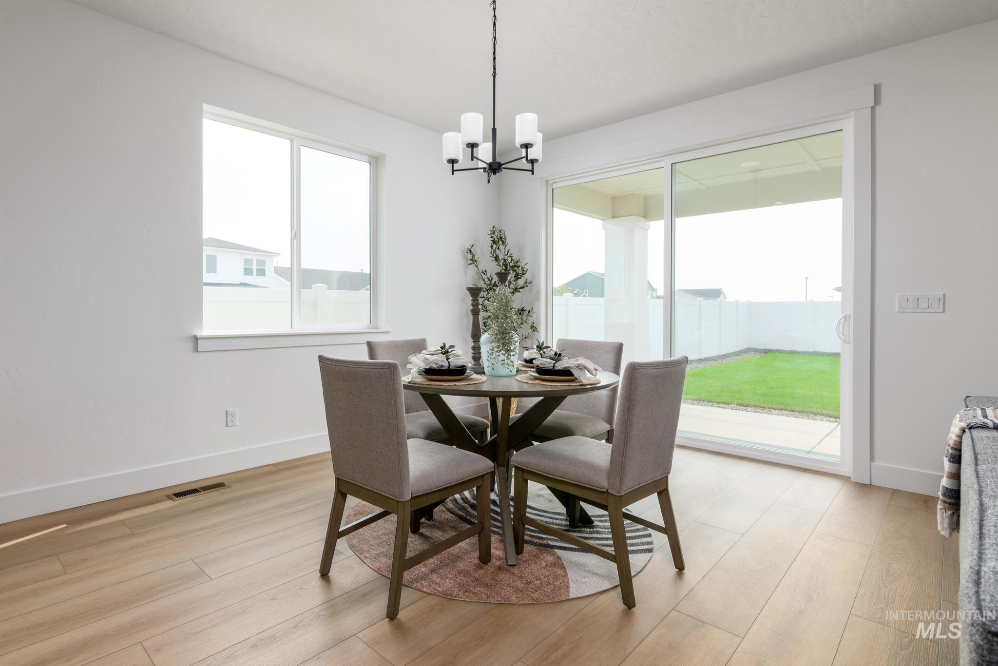 1745 West Arya Street Kuna, ID 83634 - Photo 5 of 11 Dining area featuring hanging lights and light wood-style flooring