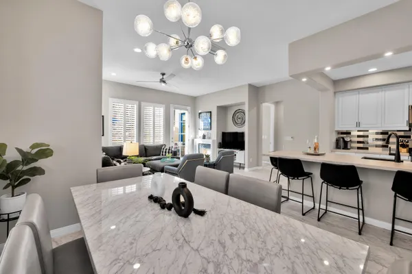 a living room with furniture potted plant and a chandelier