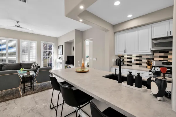 a kitchen with a counter top appliances and cabinets