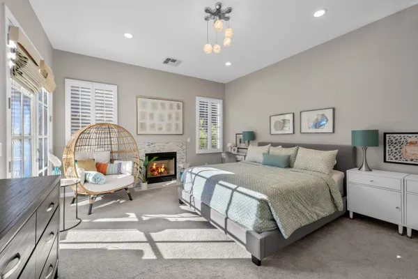 a spacious bedroom with a bed and a fireplace