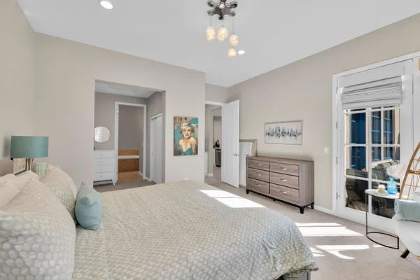 a bedroom with a bed closet and dresser