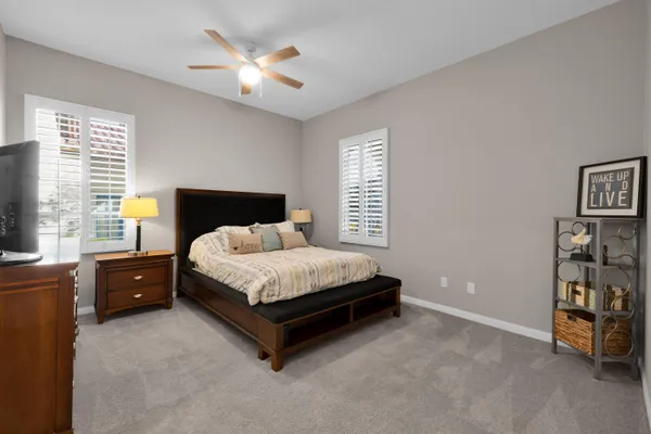 a bed sitting in a bedroom next to a window