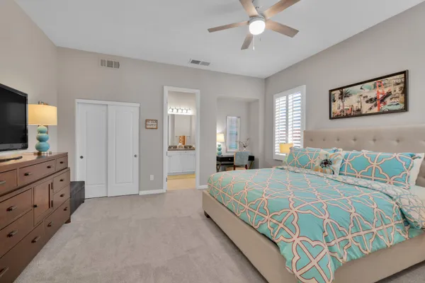 a bedroom with a bed and a chandelier