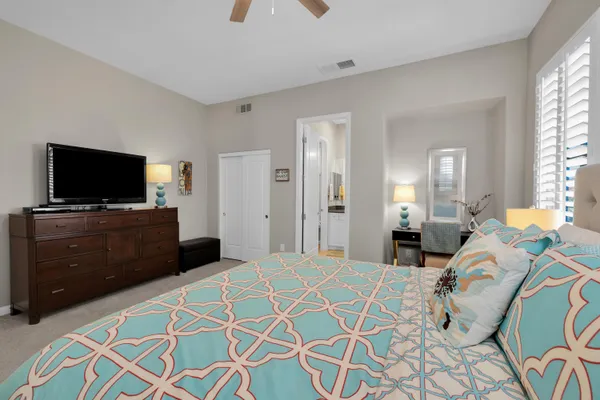 a bedroom with a bed and a flat screen tv