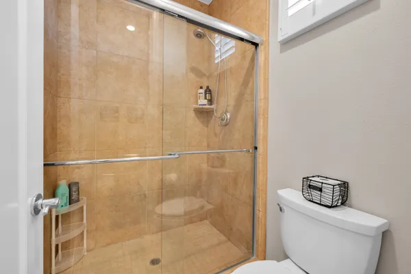 a bathroom with a shower and toilet