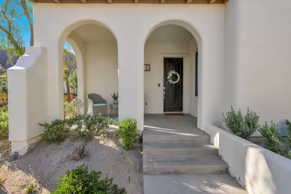 a front view of a house with outdoor seating