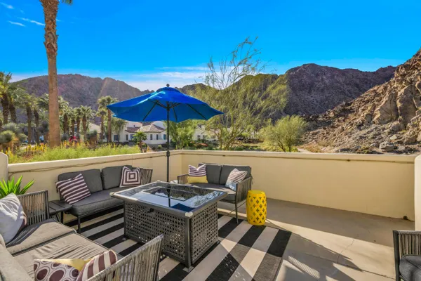 a view of a patio with couches under an umbrella