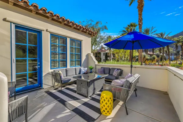 a view of a patio with a table chairs and a umbrella
