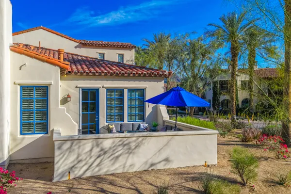 a view of a house with a yard and sitting area