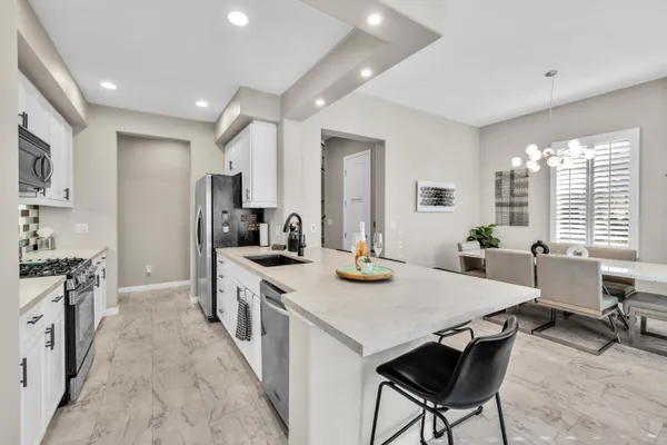 a kitchen with sink stove and refrigerator