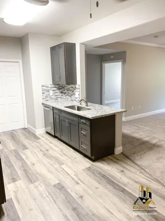 a view living room with granite countertop cabinets and sink