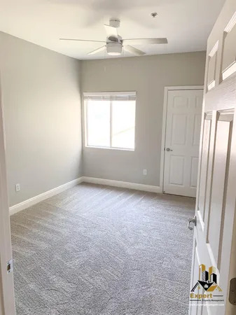 an empty room with windows and entryway