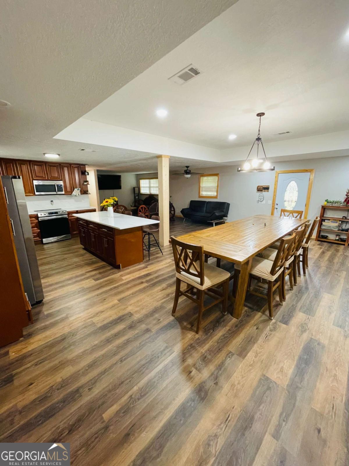 147 McLoon Road Hazlehurst, GA 31539 - Photo 11 of 38 a living room with a table chairs and a wooden floor