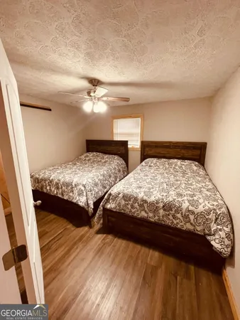 a large bed sitting in a bedroom next to a window