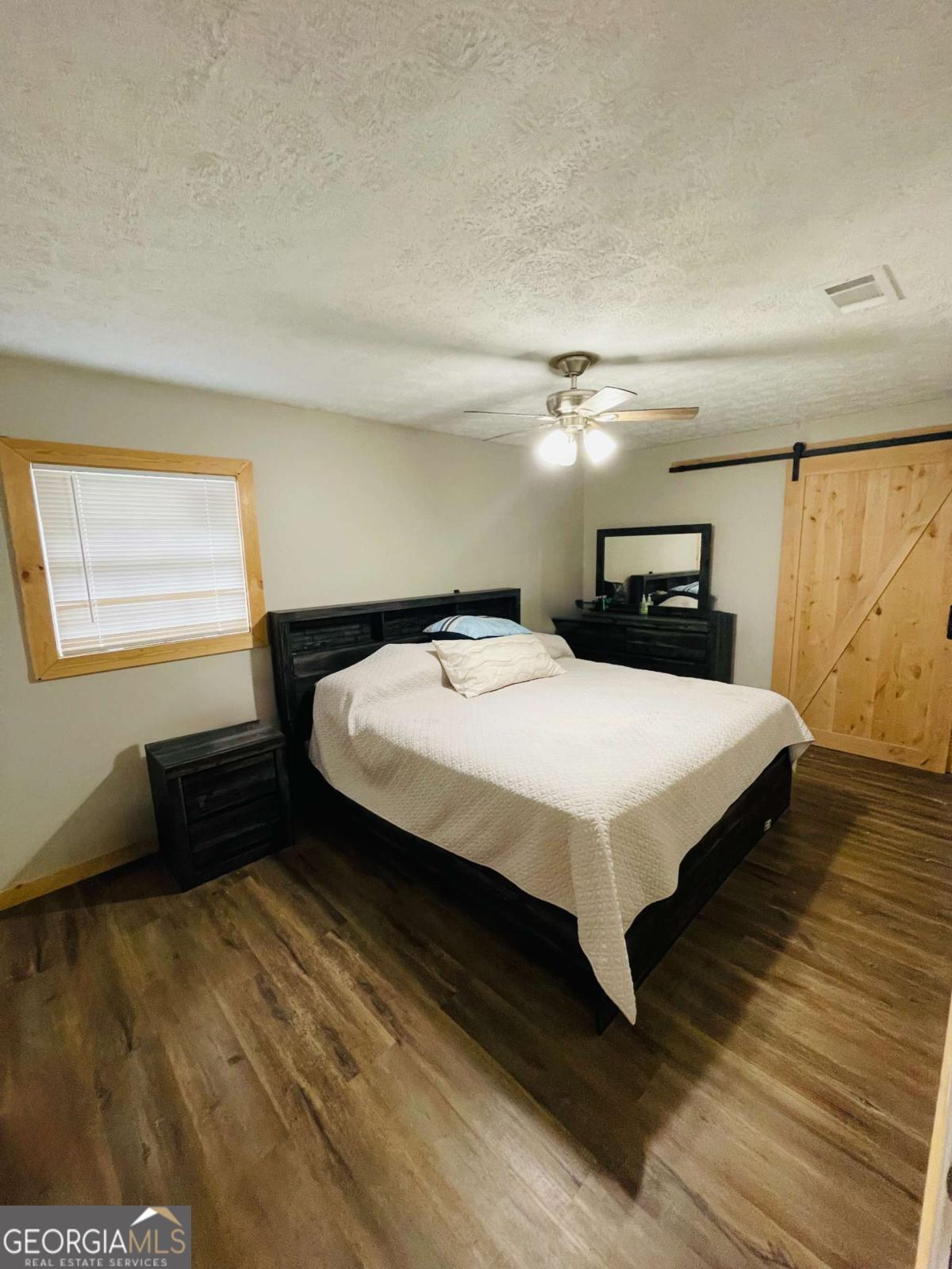 147 McLoon Road Hazlehurst, GA 31539 - Photo 13 of 38 a large bed sitting in a bedroom next to a window