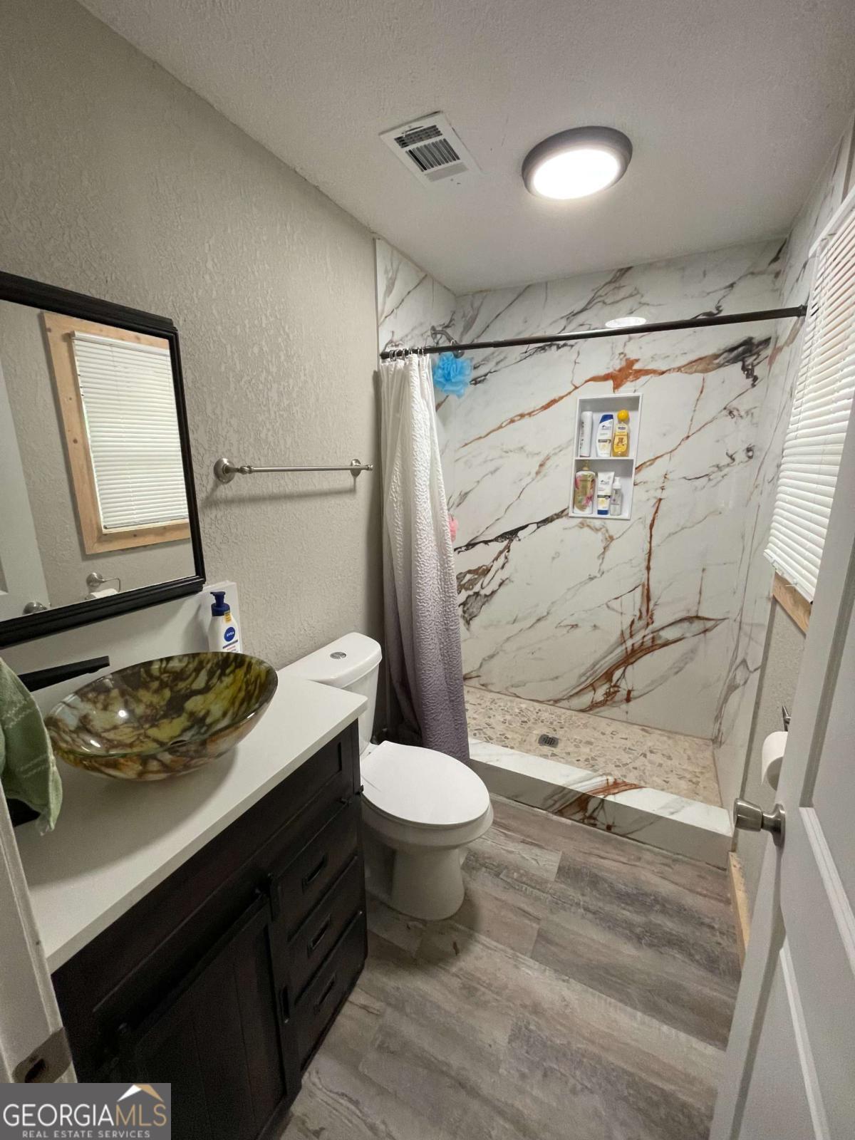 147 McLoon Road Hazlehurst, GA 31539 - Photo 14 of 38 a bathroom with a sink toilet and shower