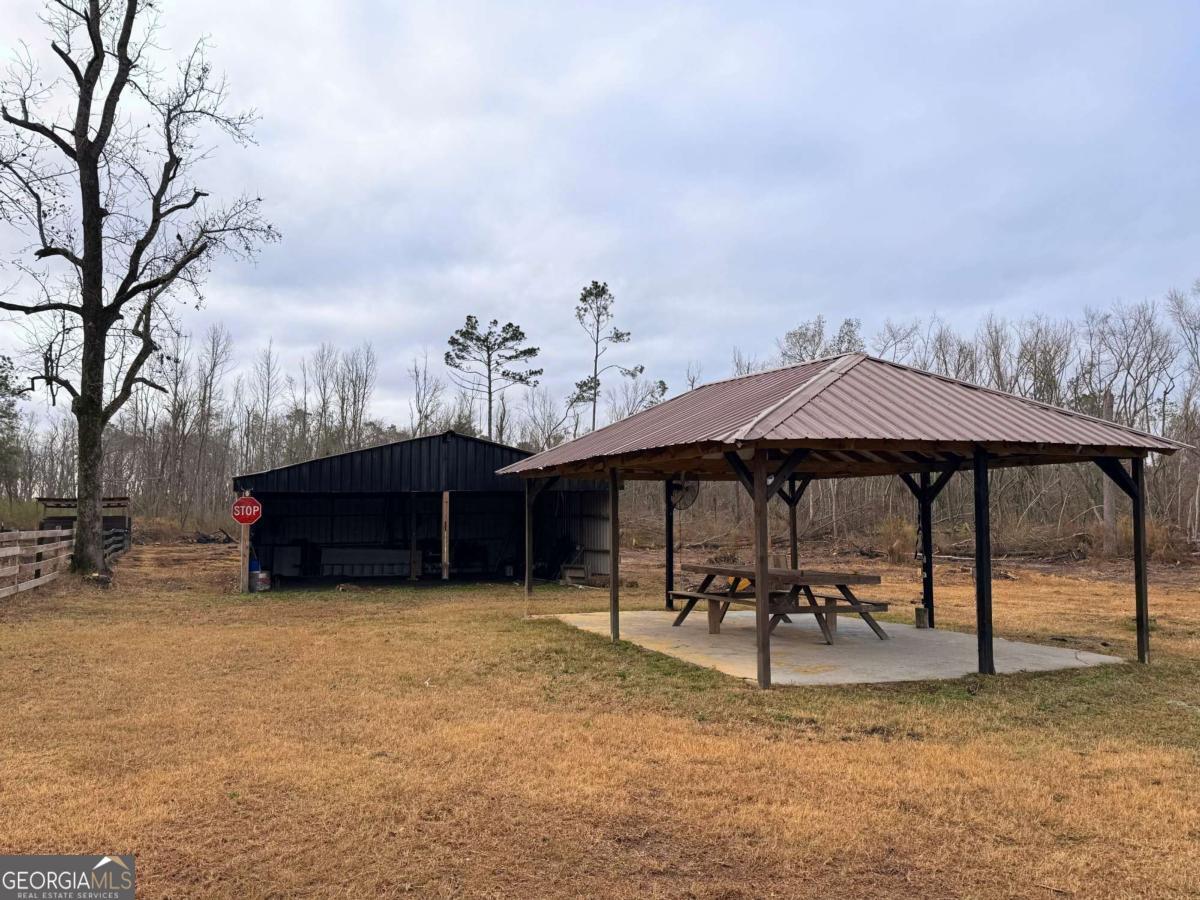 147 McLoon Road Hazlehurst, GA 31539 - Photo 20 of 38 a view of a terrace with chairs and a fire pit