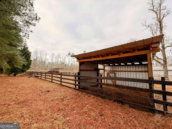 a view of a backyard with a wooden fence