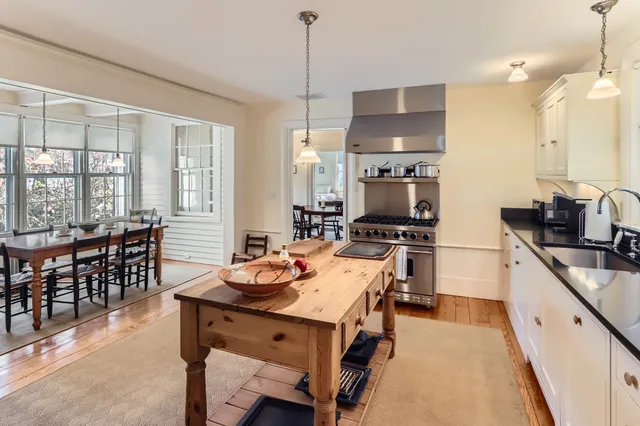 a living room with furniture a rug and a fireplace