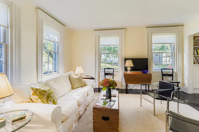 a bedroom with two beds and a large window