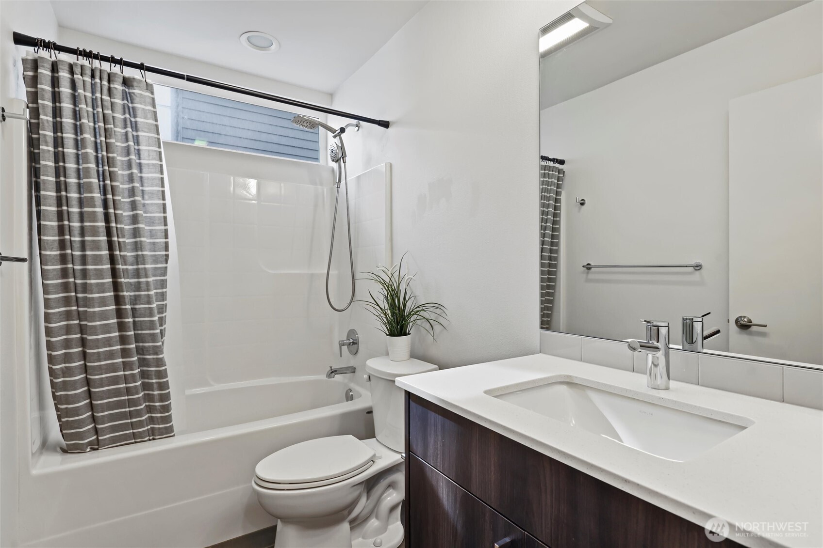 6917 Carleton Avenue South, Unit B Seattle, WA 98108 - Photo 12 of 25 a bathroom with a granite countertop sink toilet and shower