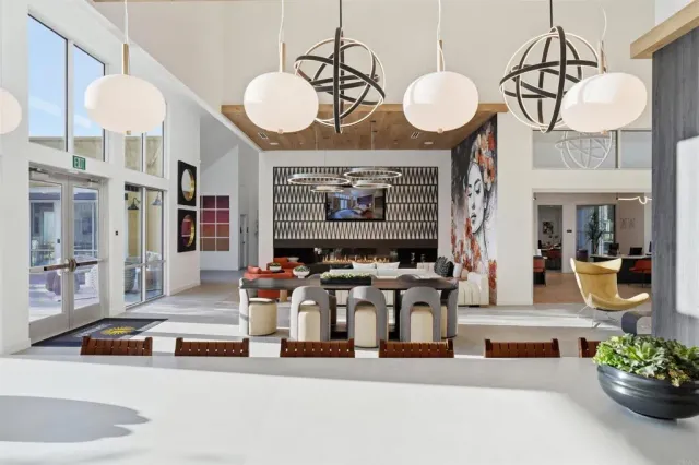 a living room with fireplace chandelier and a mirror