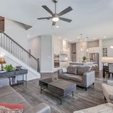 a living room with furniture and a dining table with kitchen view