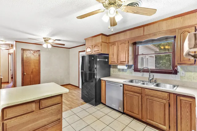 a kitchen with stainless steel appliances a sink cabinets and refrigerator
