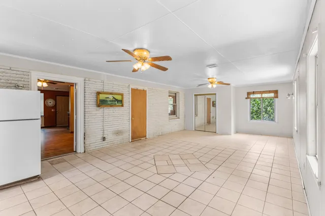 an empty room with a empty space and windows