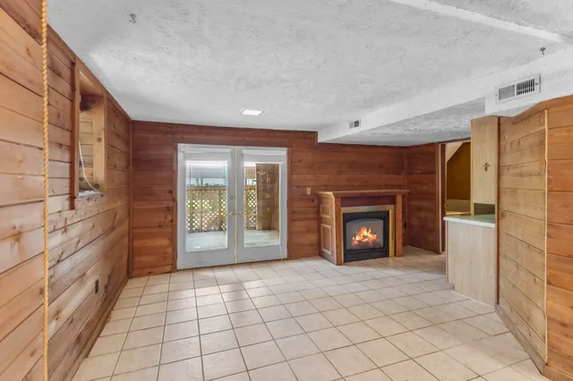 a view of a livingroom with a fireplace and window
