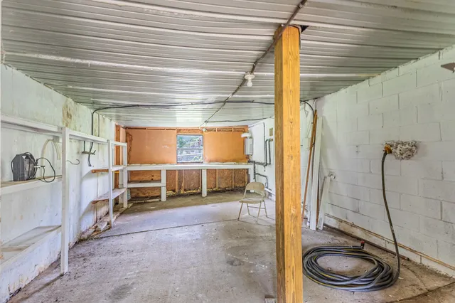 a view of a porch with wooden floor and roof with a floor to ceiling window