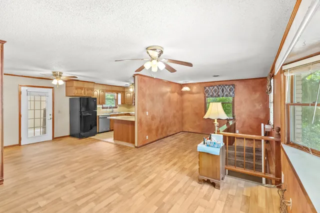 a view of a living room and dining room with wooden floor