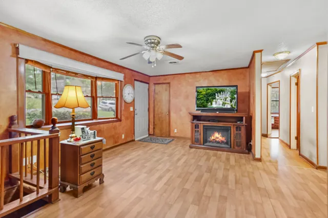 a living room with furniture a flat screen tv and a fireplace