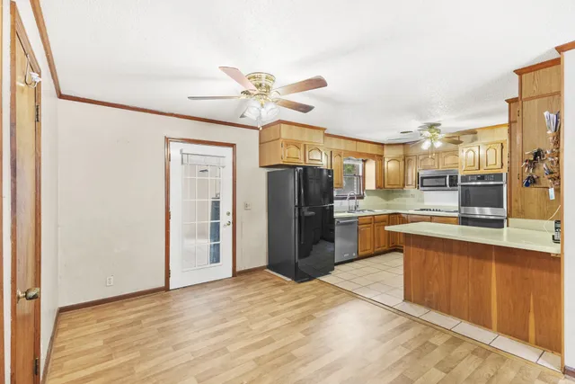 a large kitchen with cabinets and stainless steel appliances