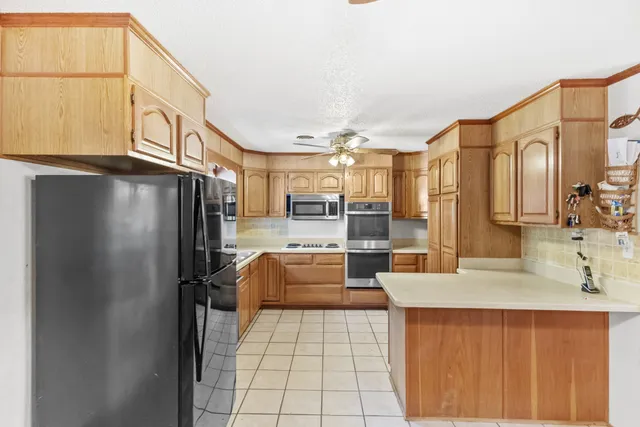 a kitchen with stainless steel appliances a refrigerator and a sink