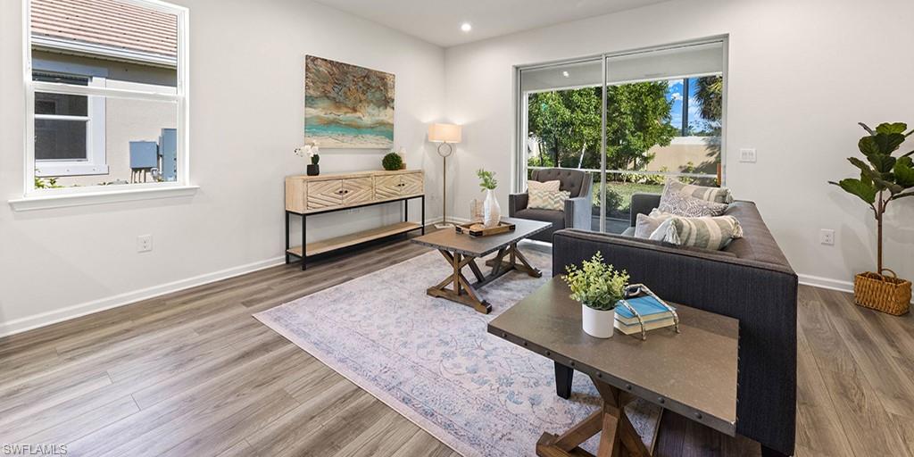 4653 Arboretum Circle, Unit 104 Naples, FL 34112 - Photo 11 of 21 a living room with furniture and a potted plant