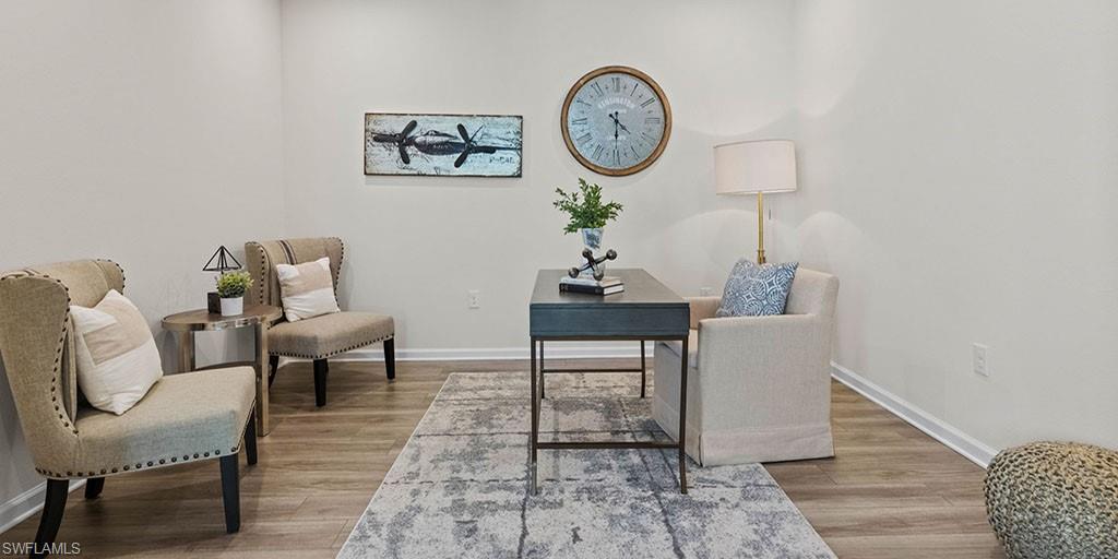 4653 Arboretum Circle, Unit 104 Naples, FL 34112 - Photo 12 of 21 a view of a room with a table and chairs