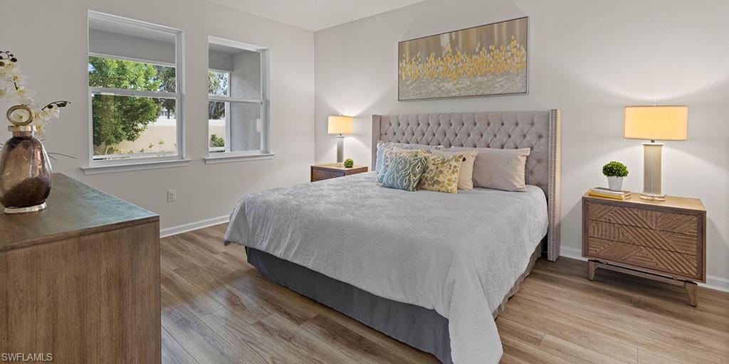 4653 Arboretum Circle, Unit 104 Naples, FL 34112 - Photo 16 of 21 a bedroom with a bed and a window