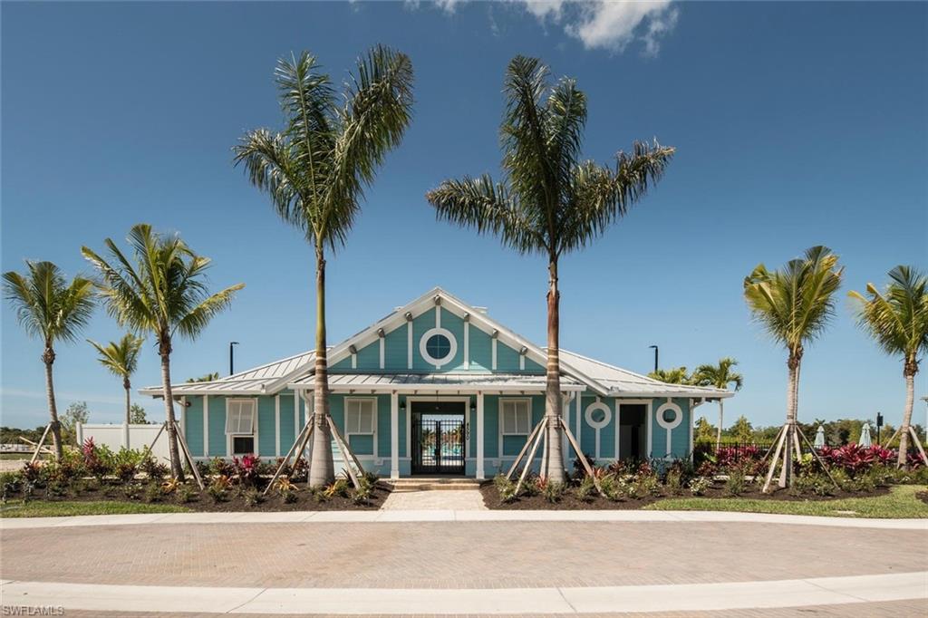 4653 Arboretum Circle, Unit 104 Naples, FL 34112 - Photo 19 of 21 a front view of a building with palm trees
