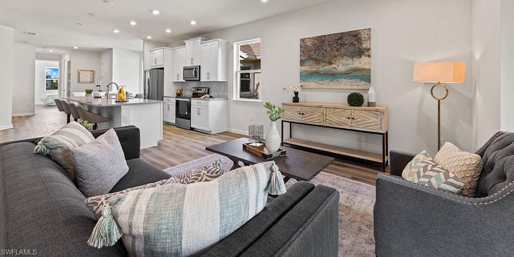 4653 Arboretum Circle, Unit 104 Naples, FL 34112 - Photo 8 of 21 a living room with furniture and a table
