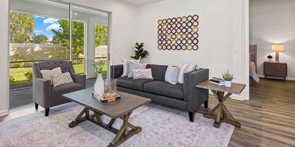 4653 Arboretum Circle, Unit 104 Naples, FL 34112 - Photo 9 of 21 a living room with furniture and a large window