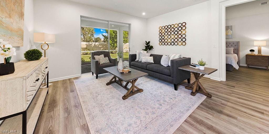 4653 Arboretum Circle, Unit 104 Naples, FL 34112 - Photo 10 of 21 a living room with furniture and a rug