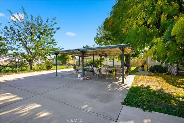a view of a patio with table and chairs and potted plants
